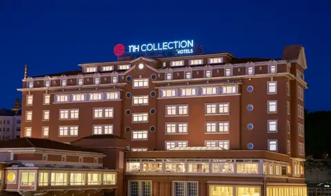 Fachada iluminada de noche del NH Collection A Coruña Finisterre