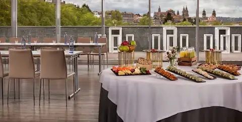Sala Obradoiro con mesa de café y vistas a la catedral de Santiago en el NH Collection